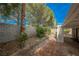 Picturesque backyard with lush landscaping, brick-paved area, and a charming porch swing for relaxation at 3213 Oyster Bay St, Las Vegas, NV 89117