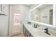 Bathroom features a double vanity, backlit mirror, and access to the backyard at 3213 Oyster Bay St, Las Vegas, NV 89117