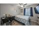 Serene bedroom with a cozy bed, stylish desk area, ceiling fan, and natural light from a side window at 3213 Oyster Bay St, Las Vegas, NV 89117