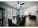 A dining room featuring a view of the living room with a fireplace and ample windows at 3213 Oyster Bay St, Las Vegas, NV 89117