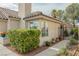 Cozy home featuring lush green bushes, flower pots and a wrought iron garden gate at 3213 Oyster Bay St, Las Vegas, NV 89117