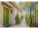 A charming front entrance with a green door, dark light fixture and a small garden at 3213 Oyster Bay St, Las Vegas, NV 89117
