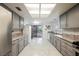 Well-lit kitchen featuring granite countertops, stainless steel appliances, and backyard access at 3213 Oyster Bay St, Las Vegas, NV 89117