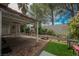 Brick patio with artificial turf, seating area, and white trellis covered patio area at 3213 Oyster Bay St, Las Vegas, NV 89117