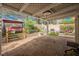 Great covered patio area with brick flooring, featuring a cozy swing and grill for outdoor enjoyment at 3213 Oyster Bay St, Las Vegas, NV 89117