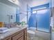 Bathroom with granite countertop, blue tiled shower, and modern fixtures at 3251 Southridge Ave, Las Vegas, NV 89121