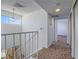 Upstairs hallway with natural light from window and carpeted floors and access to other rooms at 3251 Southridge Ave, Las Vegas, NV 89121
