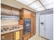 Kitchen featuring wood cabinets, stone countertops, and a combination of appliances at 3251 Southridge Ave, Las Vegas, NV 89121