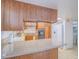 A kitchen with brown cabinets, laminate countertops, and essential appliances at 3251 Southridge Ave, Las Vegas, NV 89121