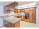 A functional kitchen with wood cabinets, laminate countertops, and essential appliances at 3251 Southridge Ave, Las Vegas, NV 89121