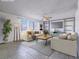 Bright living room featuring neutral furniture, ceiling fan, and large windows for natural light at 3251 Southridge Ave, Las Vegas, NV 89121
