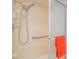 Close-up of a tiled shower with adjustable shower head and grab bar at 3251 Southridge Ave, Las Vegas, NV 89121