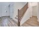 Bright entryway features wood-look floors, white doors, and a staircase with wooden railings at 3551 Via Tizzoni St, Henderson, NV 89044