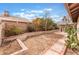 Spacious backyard with desert landscaping, brick accents, and mature trees at 3901 W Red Coach Ave, North Las Vegas, NV 89031
