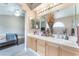 Light-filled bathroom with double sinks, vanity lighting, and access to the bedroom at 3901 W Red Coach Ave, North Las Vegas, NV 89031