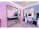 Cozy bedroom with colorful LED strip lighting, a closet with mirrored doors, and a functional vanity desk at 3901 W Red Coach Ave, North Las Vegas, NV 89031
