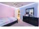 Relaxing bedroom featuring colorful LED strip lighting, a comfortable bed, and dark furniture at 3901 W Red Coach Ave, North Las Vegas, NV 89031