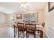 Charming dining room features a table with seating for six, tile floors, and natural lighting at 3901 W Red Coach Ave, North Las Vegas, NV 89031