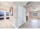 Bright hallway featuring tile flooring, neutral walls, and doors to bedrooms and living spaces at 3901 W Red Coach Ave, North Las Vegas, NV 89031