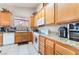 Bright kitchen featuring granite counters, and white appliances at 3901 W Red Coach Ave, North Las Vegas, NV 89031