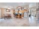 Open kitchen with a tile floor, kitchen island, breakfast table and updated appliances at 3901 W Red Coach Ave, North Las Vegas, NV 89031