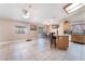 Open kitchen with a tile floor, kitchen island, and sliding glass doors to the exterior at 3901 W Red Coach Ave, North Las Vegas, NV 89031