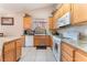 Bright kitchen featuring granite counters, a window and white appliances at 3901 W Red Coach Ave, North Las Vegas, NV 89031