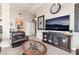 Comfortable living room featuring a large television, display cabinet, and decorative accents at 3901 W Red Coach Ave, North Las Vegas, NV 89031