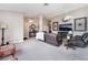 Spacious living room featuring modern furniture, carpet, and ceiling fans at 3901 W Red Coach Ave, North Las Vegas, NV 89031
