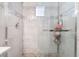 Detailed shower with glass doors, sleek hardware, and tiled walls and flooring at 3901 W Red Coach Ave, North Las Vegas, NV 89031