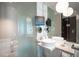 A contemporary bathroom with dual sinks, ample counter space, and a mirror at 4381 W Flamingo Rd # 3303, Las Vegas, NV 89103