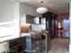 Compact kitchenette with stainless steel details, breakfast bar, and modern lighting fixture at 4381 W Flamingo Rd # 3303, Las Vegas, NV 89103