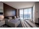 Bright living room featuring a gray sectional sofa and floor-to-ceiling windows with a beautiful view at 4381 W Flamingo Rd # 3303, Las Vegas, NV 89103