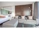 Comfortable living room with a plush gray couch and a bedroom with a mirrored wall in the background at 4381 W Flamingo Rd # 3303, Las Vegas, NV 89103