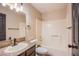 Bathroom featuring granite counters, a large mirror, and a shower-tub combo with white tile surround at 5174 S Jones Blvd # 101, Las Vegas, NV 89118