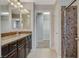 Bathroom with long vanity, dual mirrors, and glass enclosed shower at 5309 Tartan Hill Ave, Las Vegas, NV 89141