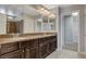 Bathroom with long vanity, dual mirrors, and glass enclosed shower at 5309 Tartan Hill Ave, Las Vegas, NV 89141