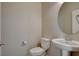 Powder room with pedestal sink, round mirror and white toilet at 5309 Tartan Hill Ave, Las Vegas, NV 89141