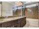 Bathroom features granite countertops, dark wood cabinets, and a shower-tub combo at 5309 Tartan Hill Ave, Las Vegas, NV 89141