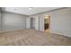 Large bedroom with neutral carpet and access to the hallway and bathroom at 5309 Tartan Hill Ave, Las Vegas, NV 89141