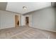 A carpeted primary bedroom with multiple closets and a tray ceiling at 5309 Tartan Hill Ave, Las Vegas, NV 89141