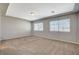 Spacious bedroom with neutral carpet, gray walls and large windows at 5309 Tartan Hill Ave, Las Vegas, NV 89141