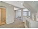 Hallway leading to an open living space and featuring neutral carpet and a half bathroom at 5309 Tartan Hill Ave, Las Vegas, NV 89141