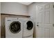 Functional laundry room with a stacked washer and dryer unit, optimizing space and convenience at 5309 Tartan Hill Ave, Las Vegas, NV 89141