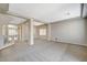 Open living room with neutral carpet, tray ceilings, recessed lights, and wide doorways to other rooms at 5309 Tartan Hill Ave, Las Vegas, NV 89141