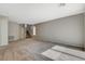 A sprawling living area with neutral tones, carpet, and a staircase at 5309 Tartan Hill Ave, Las Vegas, NV 89141