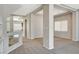 Open living room with neutral carpet and wide doorways to other rooms and kitchen at 5309 Tartan Hill Ave, Las Vegas, NV 89141