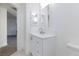 Bright bathroom features a white vanity with stainless steel hardware and a framed mirror at 5855 Valley Dr # 2018, North Las Vegas, NV 89031