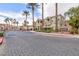 Gated Jasmine community entrance featuring lush landscaping and well-maintained buildings at 5855 Valley Dr # 2018, North Las Vegas, NV 89031