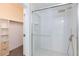 Shower with a clear glass door, rain style shower head, and niche shelving at 5855 Valley Dr # 2018, North Las Vegas, NV 89031